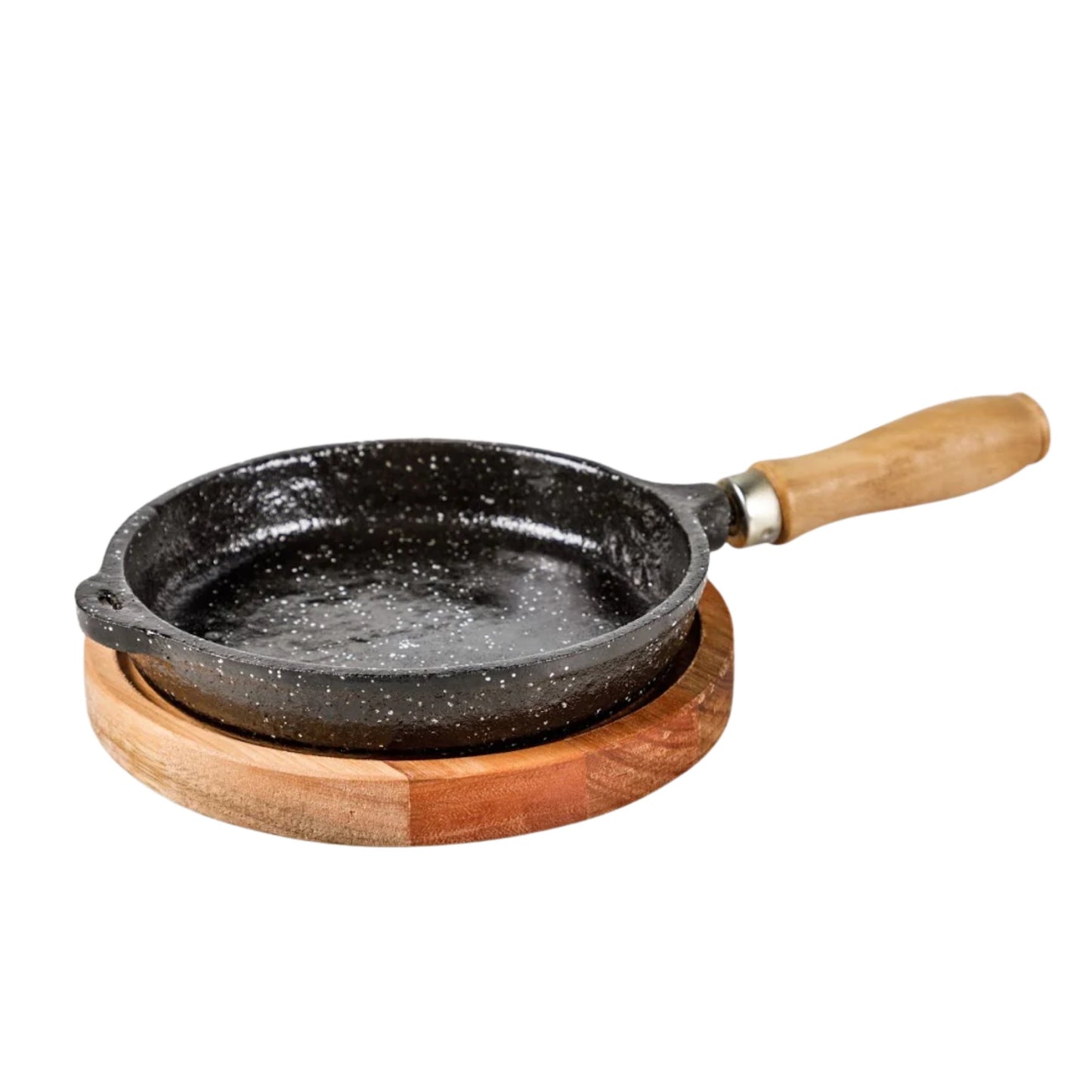 Small black speckled frying pan with wooden handle on a wooden trivet against a white background