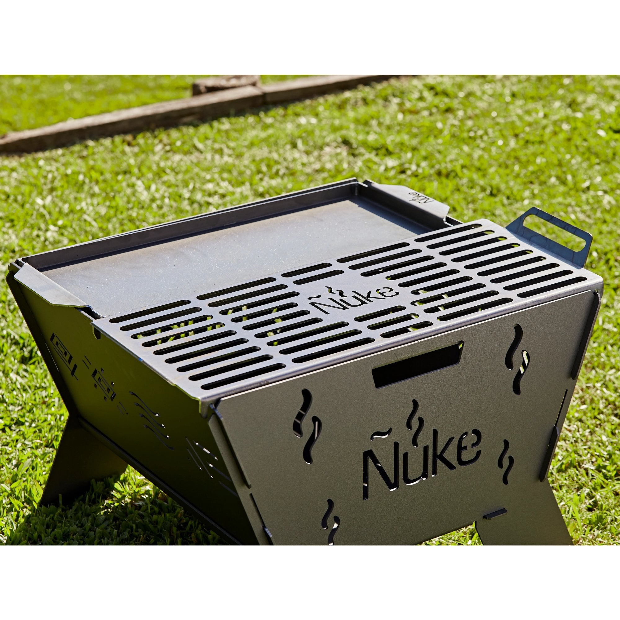 Portable grill with 'Nuke' branding on a grassy background